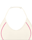 Closeup of halter neckline and contrast stitching on TrackLine Halter Yoga Top in apricot