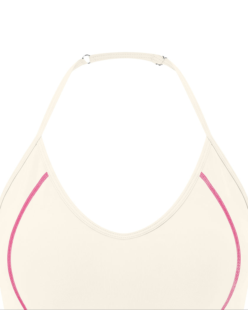 Closeup of halter neckline and contrast stitching on TrackLine Halter Yoga Top in apricot