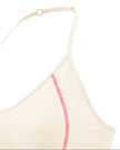 Side angle closeup showing contrast stitching on TrackLine Halter Yoga Top in apricot