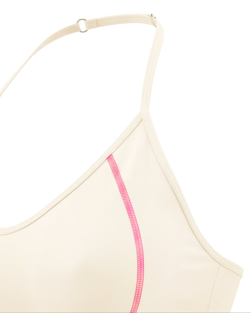 Side angle closeup showing contrast stitching on TrackLine Halter Yoga Top in apricot
