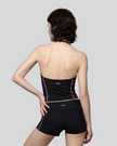 Mid body back view of woman wearing TrackLine Halter Yoga Top in black