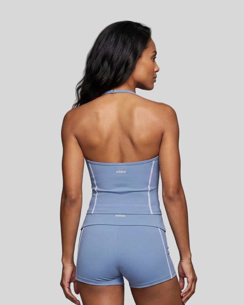 Mid body back view of woman wearing TrackLine Halter Yoga Top in blue