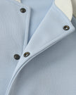 Snap button front closure detail of TrackLine Heritage Jacket in Light Blue with Apricot