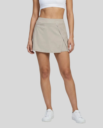Lower body front view of a woman wearing the Athlesi TrackLine Heritage Skirt in light coffee