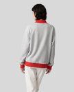 Model wearing the Athlesi TrackLine Heritage Sweatshirt in flower gray with red contrast trim, back view
