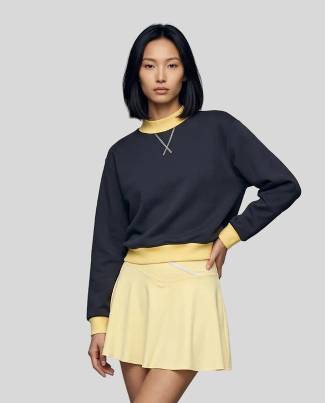 Model wearing the Athlesi TrackLine Heritage Sweatshirt in navy blue with yellow contrast trim, front view
