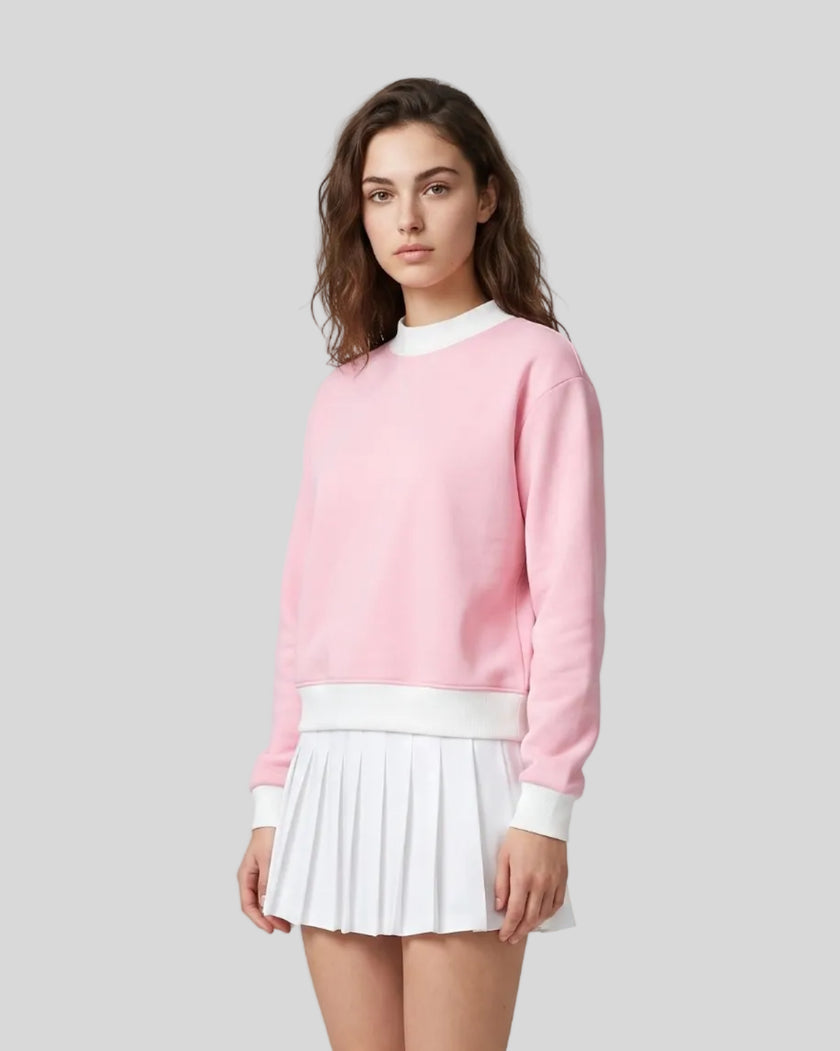 Model wearing the Athlesi TrackLine Heritage Sweatshirt in pink with white contrast trim, front view
