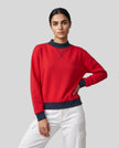 Model wearing the Athlesi TrackLine Heritage Sweatshirt in red with navy blue contrast trim, front view