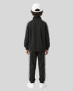 Back view of a child wearing the TrackLine Junior Club Jacket in Black