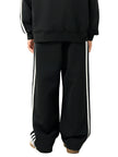 Back view of a child wearing the TrackLine Junior Club Pants in Black