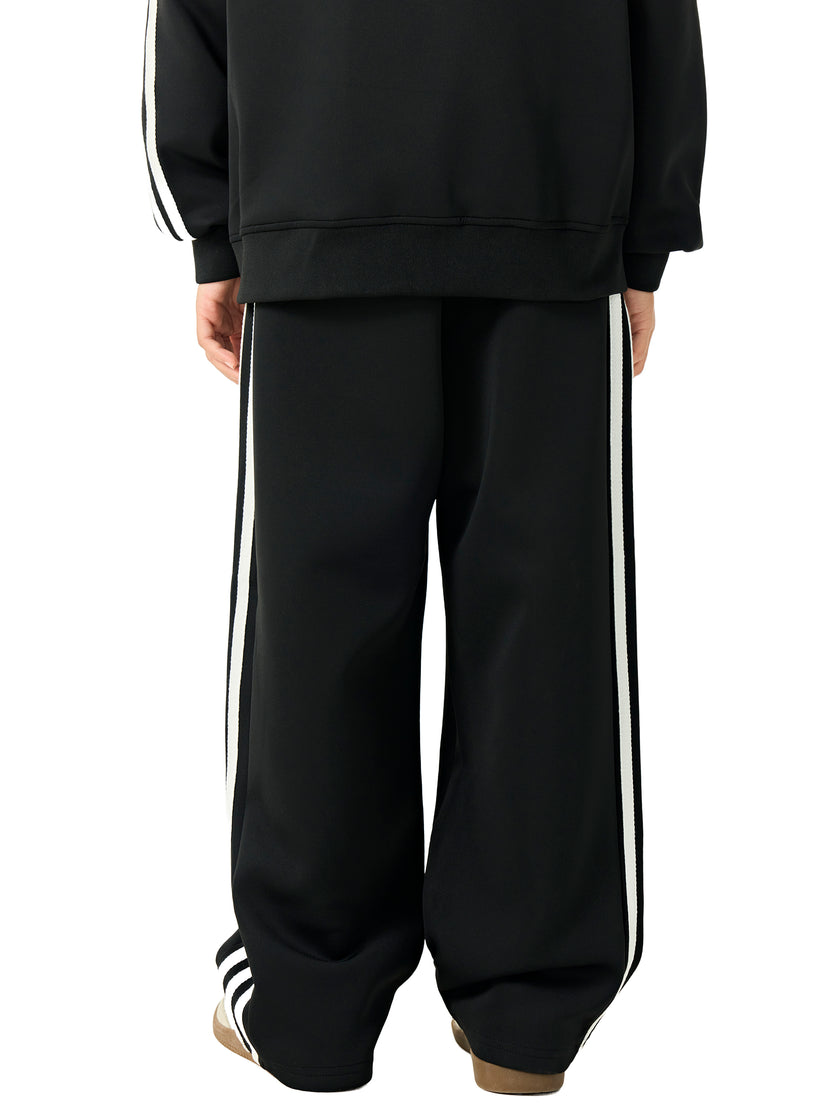 Back view of a child wearing the TrackLine Junior Club Pants in Black