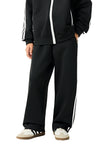 Angled front view of a child wearing the TrackLine Junior Club Pants in Black