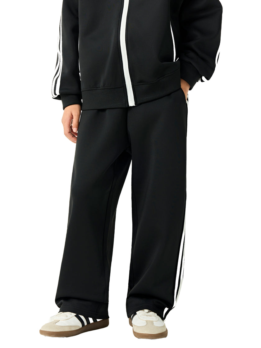 Angled front view of a child wearing the TrackLine Junior Club Pants in Black