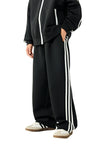 Side angle view of a child wearing the TrackLine Junior Club Pants in Black