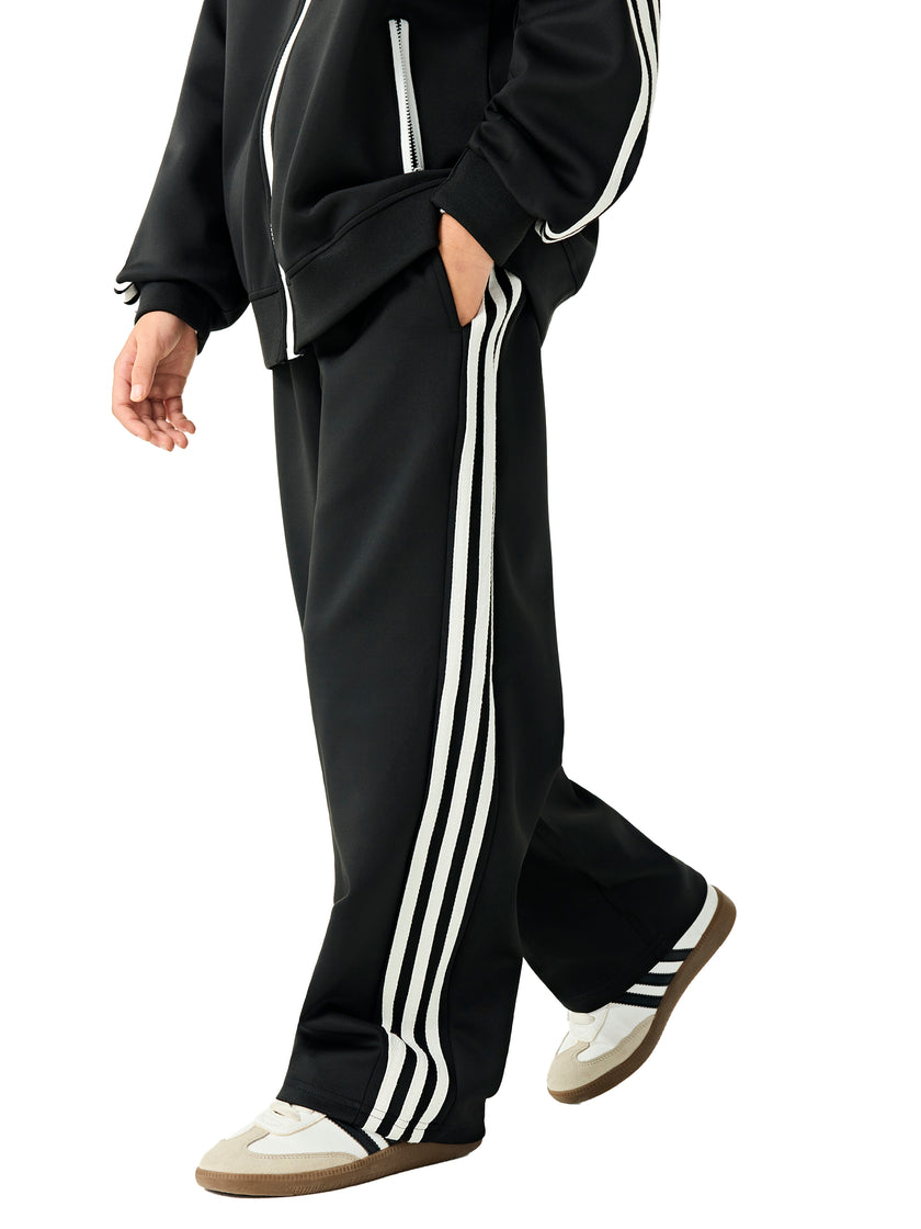Side view of a child wearing the TrackLine Junior Club Pants in Black