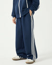 Side angle view of a child wearing the TrackLine Junior Club Pants in Royal Blue