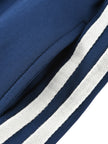 Side pocket and contrast stripe detail on the TrackLine Junior Club Pants in Royal Blue