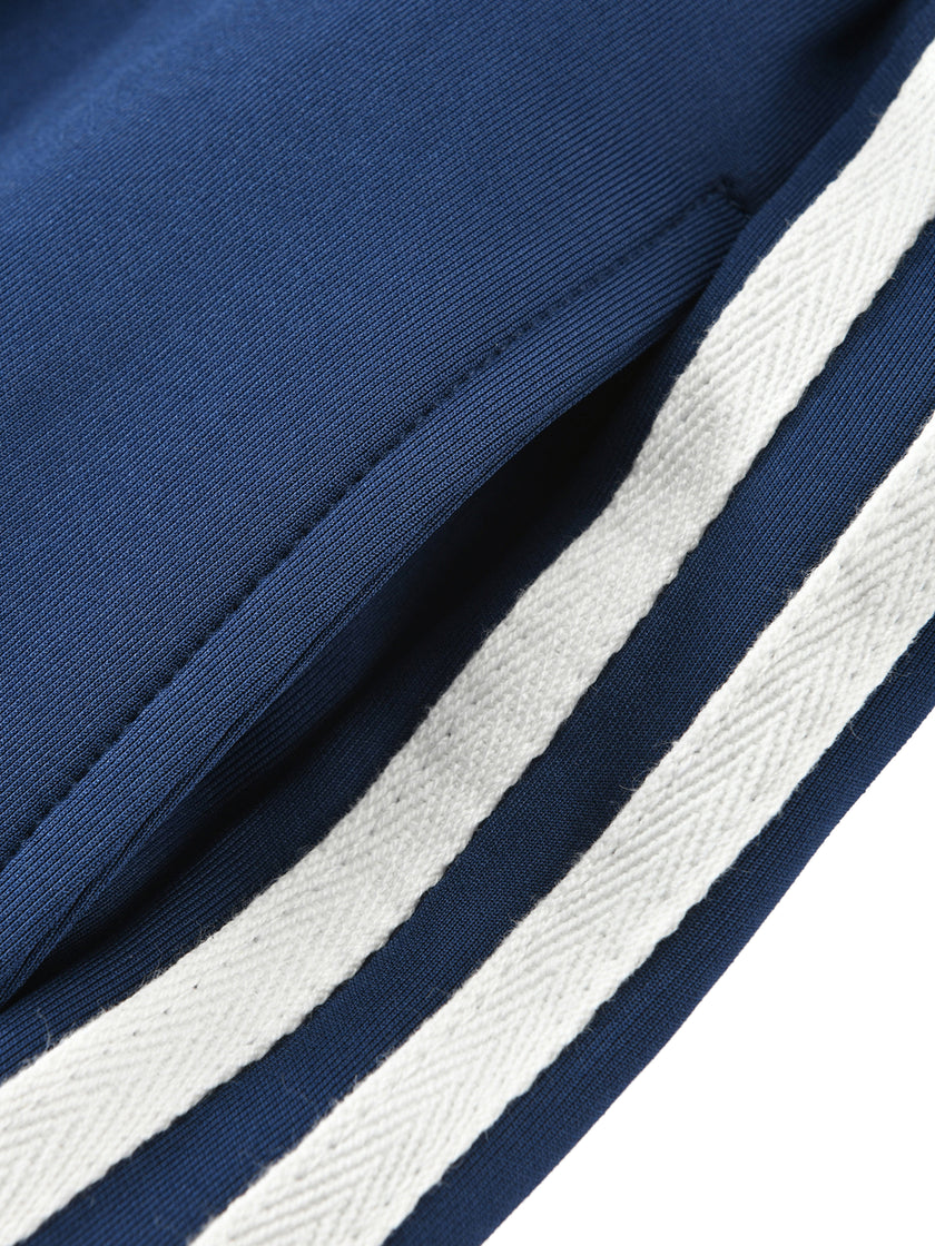 Side pocket and contrast stripe detail on the TrackLine Junior Club Pants in Royal Blue