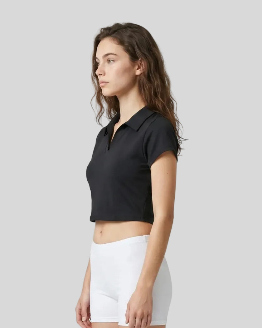 Side view of a woman wearing the Athlesi TrackLine Lapel Crop Top in black