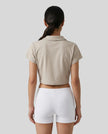 Lower body back styling view featuring the Athlesi TrackLine Lapel Crop Top in light coffee