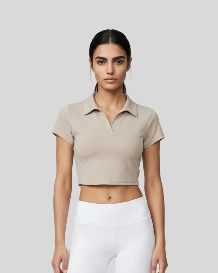 Upper body front view of a woman wearing the Athlesi TrackLine Lapel Crop Top in light coffee