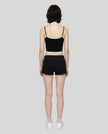Model wearing TrackLine Lounge Halter Tank in black and white with Trackline Lounge Shorts in black back view
