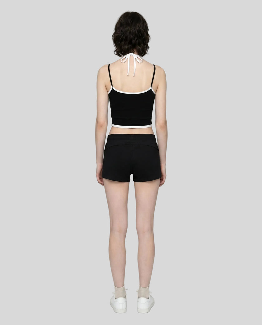 Model wearing TrackLine Lounge Halter Tank in black and white with Trackline Lounge Shorts in black back view