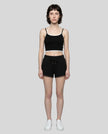Model wearing TrackLine Lounge Halter Tank in black and white with Trackline Lounge Shorts in black front view