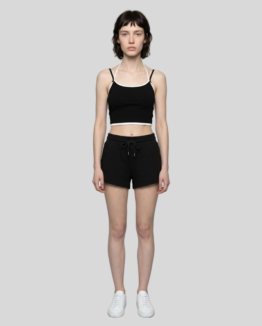 Model wearing TrackLine Lounge Halter Tank in black and white with Trackline Lounge Shorts in black front view
