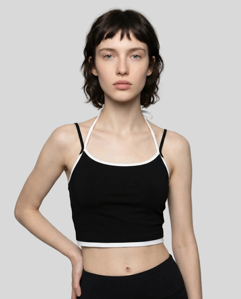 Model wearing TrackLine Lounge Halter Tank in black and white front view