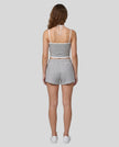 Model wearing TrackLine Lounge Halter Tank in flower gray and white with Trackline Lounge Shorts in flower gray back view