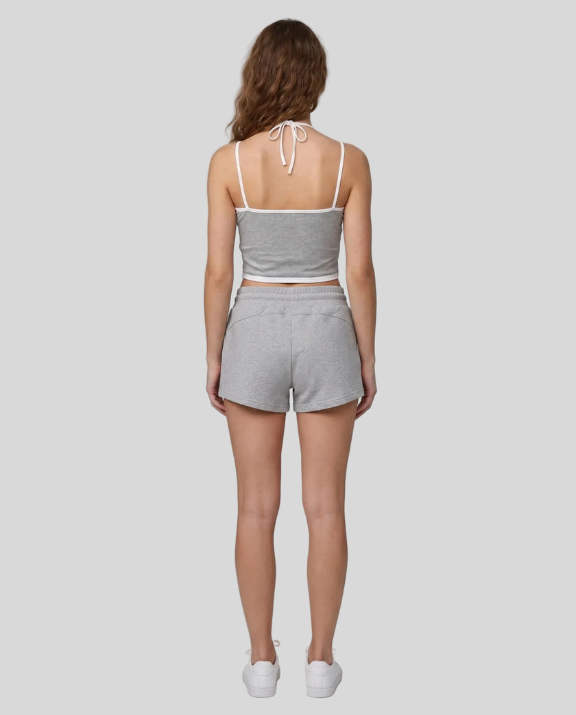 Model wearing TrackLine Lounge Halter Tank in flower gray and white with Trackline Lounge Shorts in flower gray back view