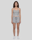 Model wearing TrackLine Lounge Halter Tank in flower gray and white with Trackline Lounge Shorts in flower gray front view
