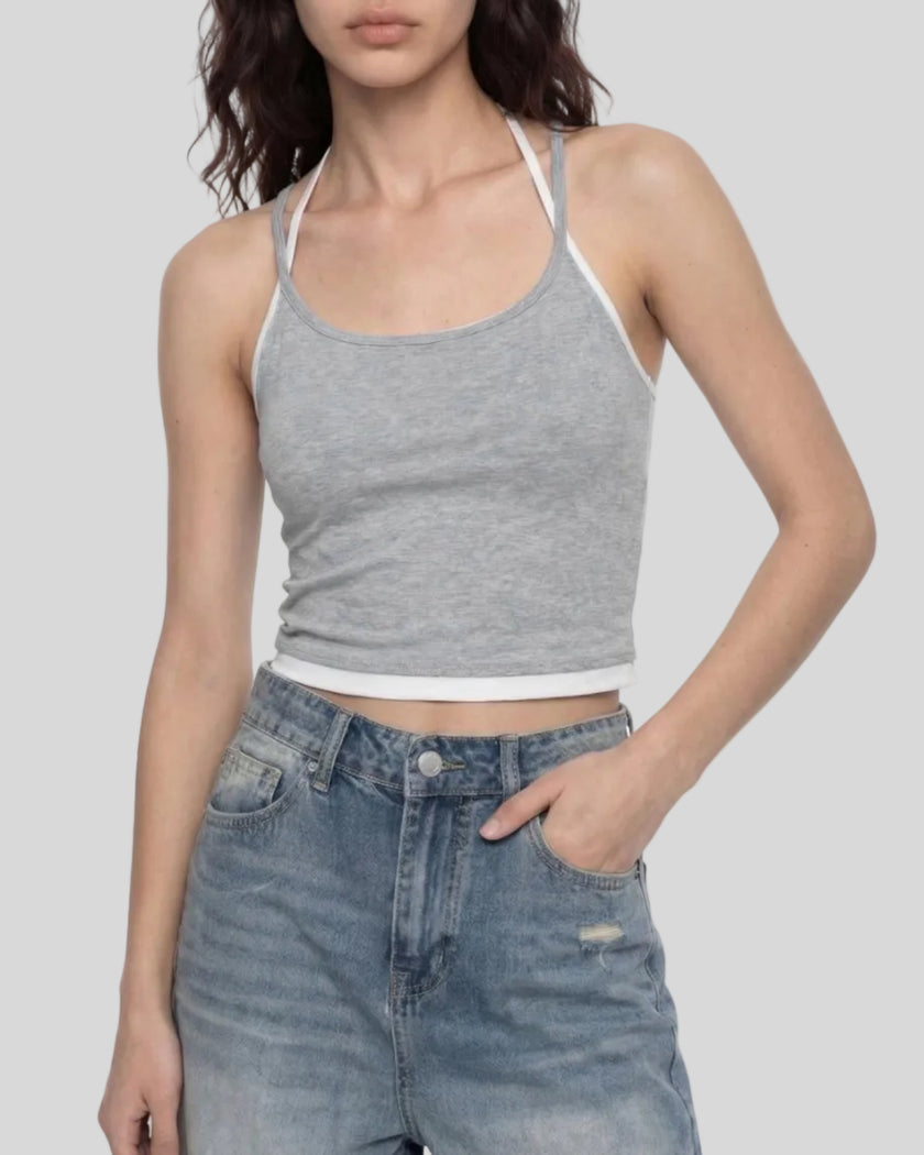 Model wearing TrackLine Lounge Halter Tank in flower gray and white with jeans front view