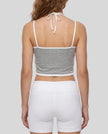 Back view of model wearing TrackLine Lounge Halter Tank featuring open halter silhouette