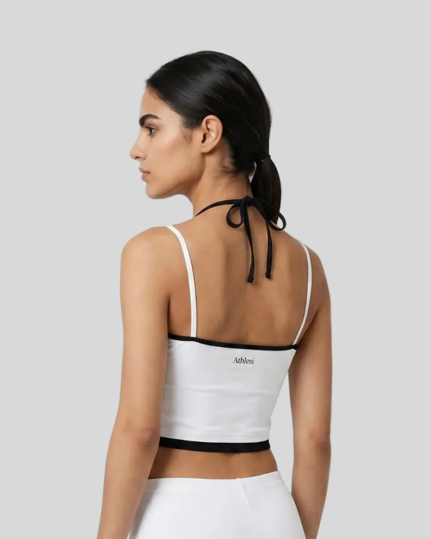 Back view of model wearing white and black TrackLine Lounge Halter Tank featuring open halter silhouette