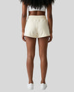 Back view of model wearing TrackLine Lounge Shorts in apricot