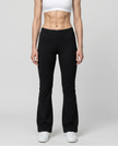 Woman wearing TrackLine Lounge Sweatpants in black front view with relaxed flared silhouette