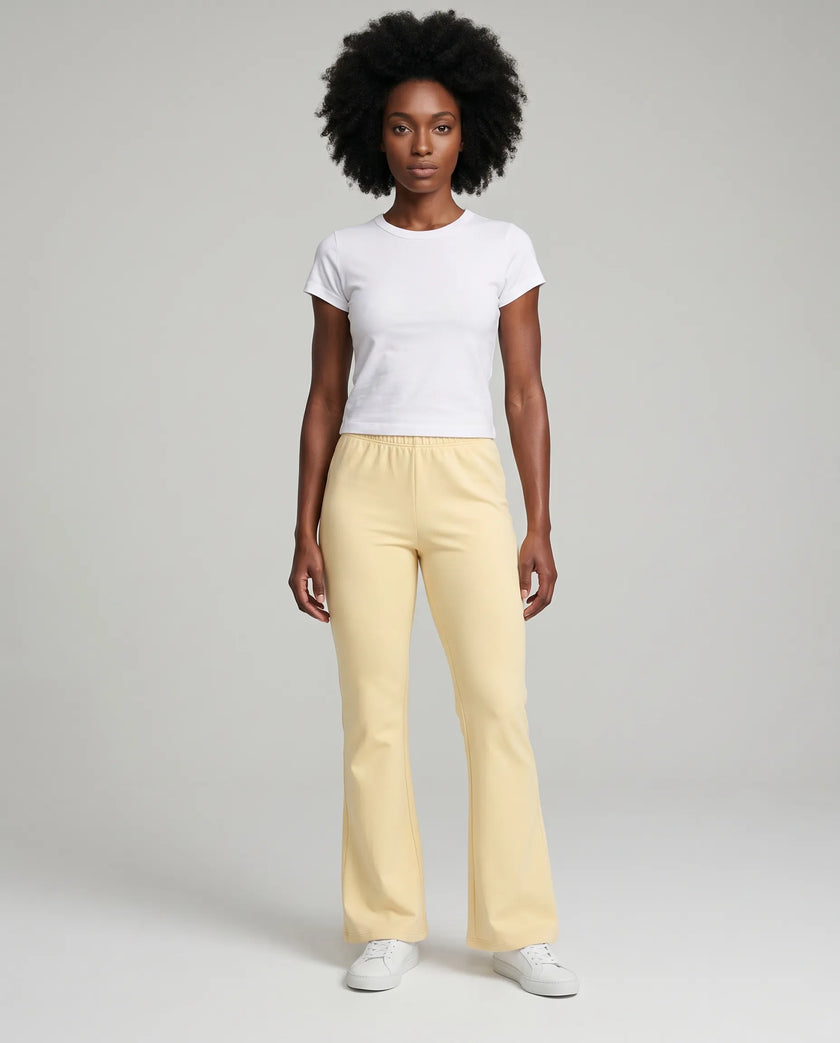 Full body front view of TrackLine Lounge Sweatpants in light apricot and Trackline Lounge Tee in white