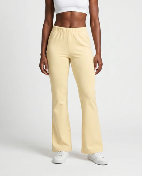 Woman wearing TrackLine Lounge Sweatpants in light apricot front view with relaxed flared silhouette