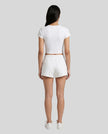 Back view of model wearing TrackLine Lounge Tee in white with matching Trackline Lounge Shorts