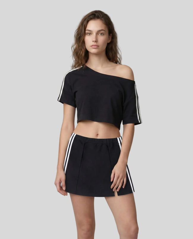 Woman wearing black Trackline Off-Shoulder Tee paired with black Trackline Slit Skirt