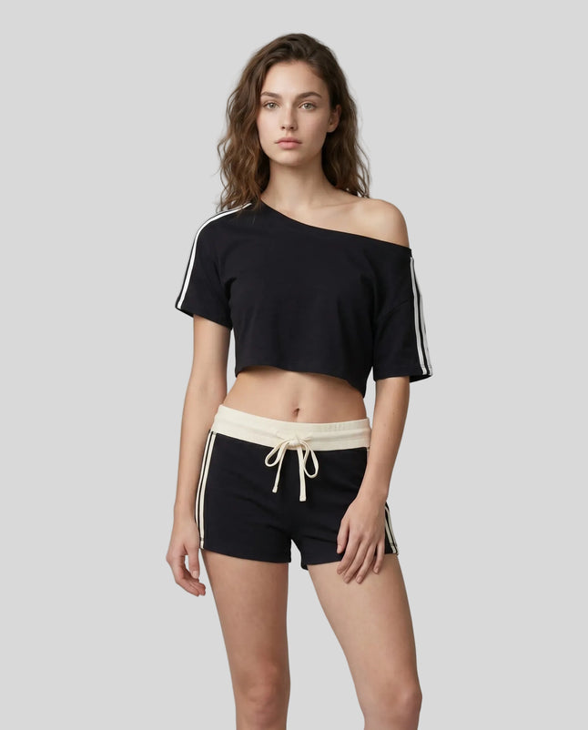 Woman wearing black Trackline Off-Shoulder Tee paired with black Trackline Track Shorts