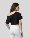 Upper body back view of the Athlesi TrackLine Off-Shoulder Tee in black