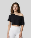 Upper body front view of a woman wearing the Athlesi TrackLine Off-Shoulder Tee in black