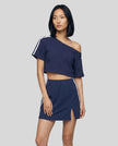 Woman wearing blue Trackline Off-Shoulder Tee paired with blue Trackline Slit Skirt