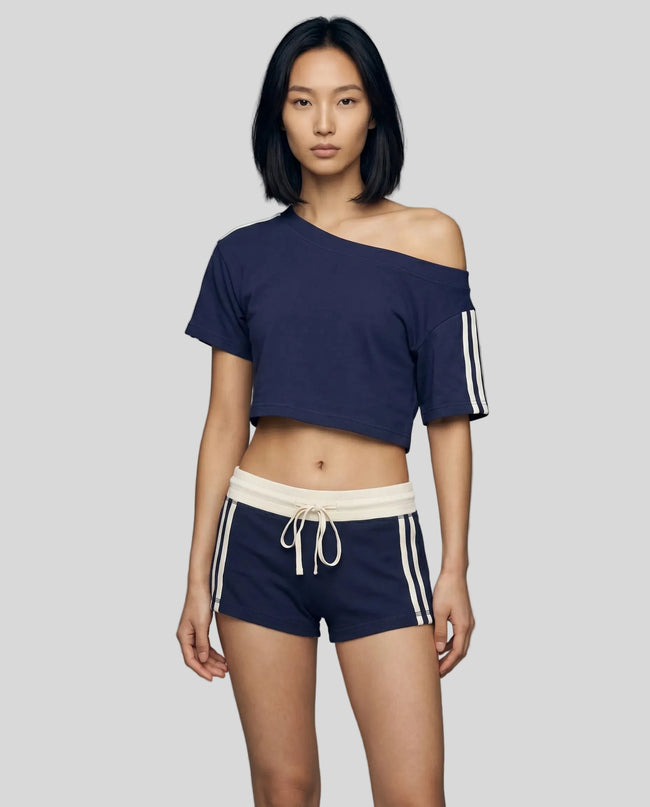 Woman wearing blue Trackline Off-Shoulder Tee paired with blue Trackline Track Shorts