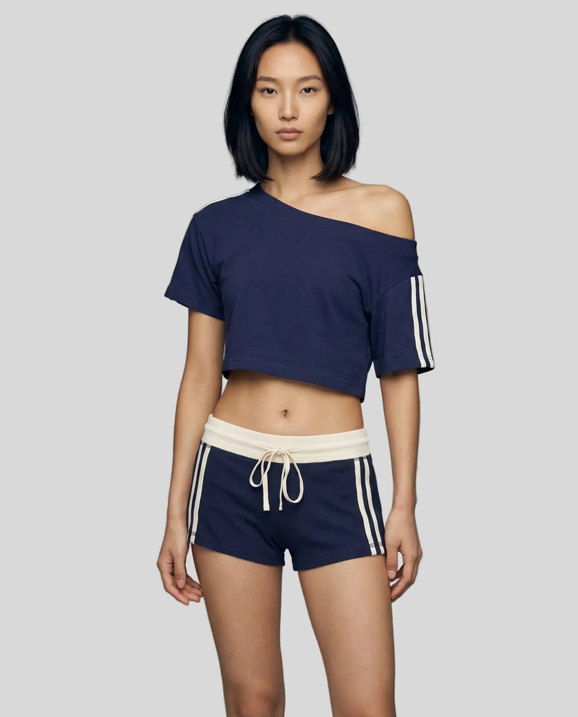 Woman wearing blue Trackline Off-Shoulder Tee paired with blue Trackline Track Shorts