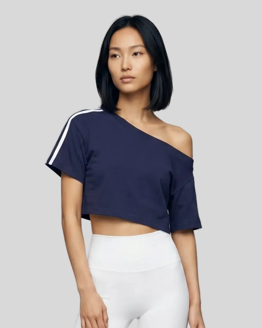 Upper body front view of a woman wearing the Athlesi TrackLine Off-Shoulder Tee in blue