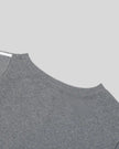 Back neckline closeup of the Athlesi TrackLine Off-Shoulder Tee in gray
